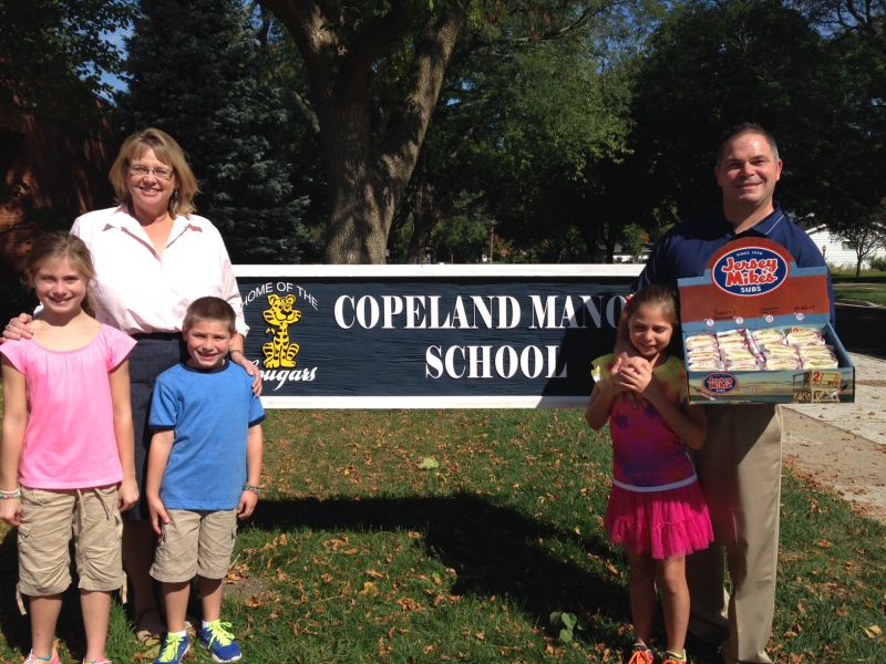 Jersey Mike’s Franchisee and Area Director Jeff Berns (far right, getdate(), getdate() ), along with his children Alexandra, Peter and Lauren (r., getdate(), getdate() ), delivered a sub tray to Lori Poelking, principal, Copeland Manor School in Libertyville to kick off Jersey Mike's "Subs for Schools" Fundraising Campaign in the month of October.  Copeland is just one of the many Chicagoland schools that will benefit from this fundraiser.  Thirty-five area Jersey Mike’s restaurants hope to raise $250,000 during the month.