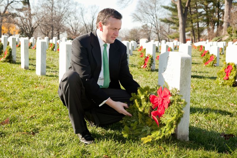 Franchise owner Danny Malamis places a wreath on a grave in Arlington National Cemetery December 2012.